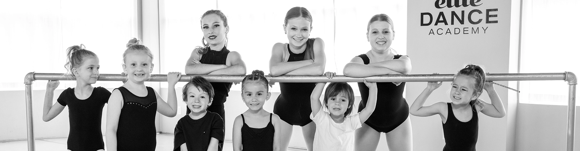 Girls posing for group photo in dance class
